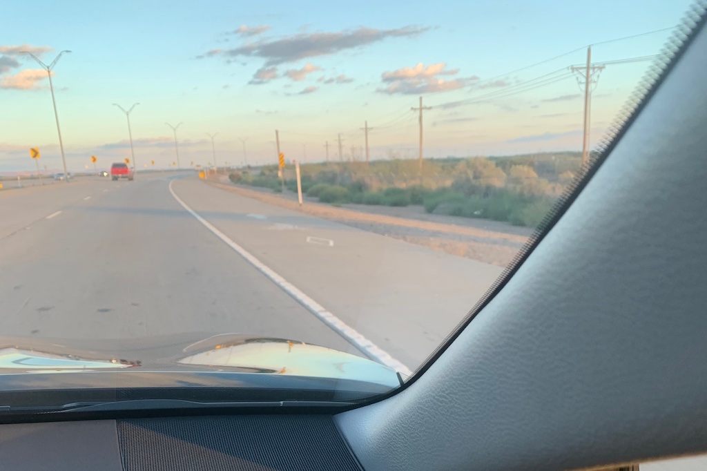 A highway with a wide bike lane but no protection and a 80 mph speed limit
