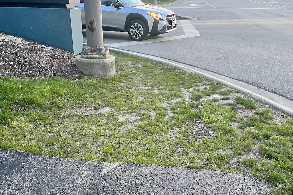 showing a bike path in OakBrook Village that ends with a grass patch then an intersection