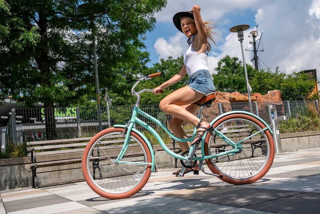 Woman riding a Priority Coast cruiser bike